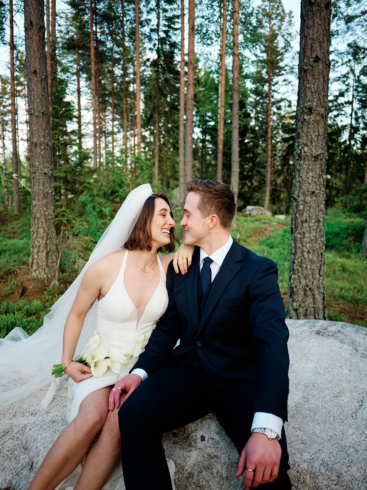 Bride backlit by sunset during elopement session on the Swedish coast