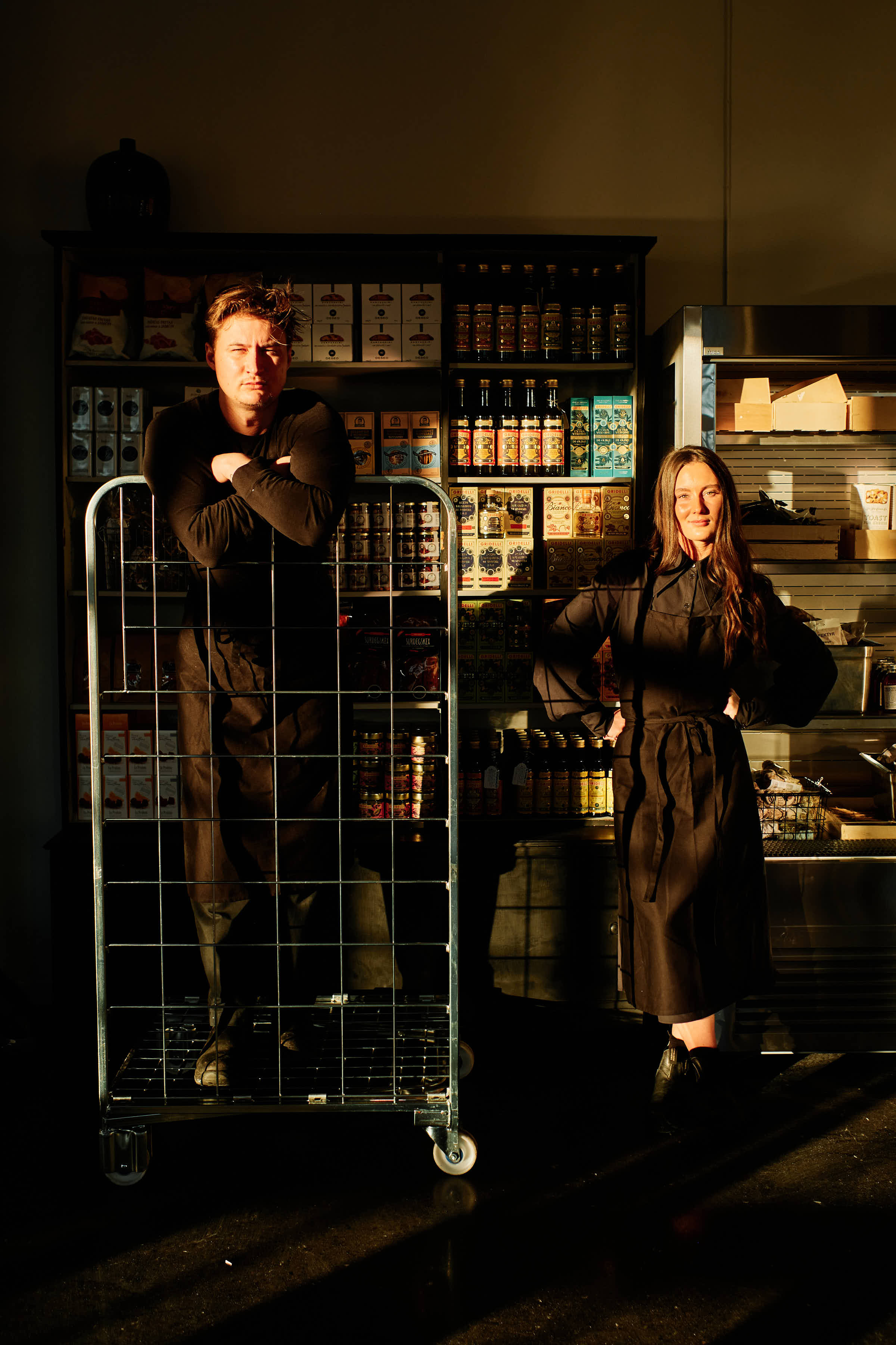 Salt Studio Gävle owners standing by deli provisions and shelves