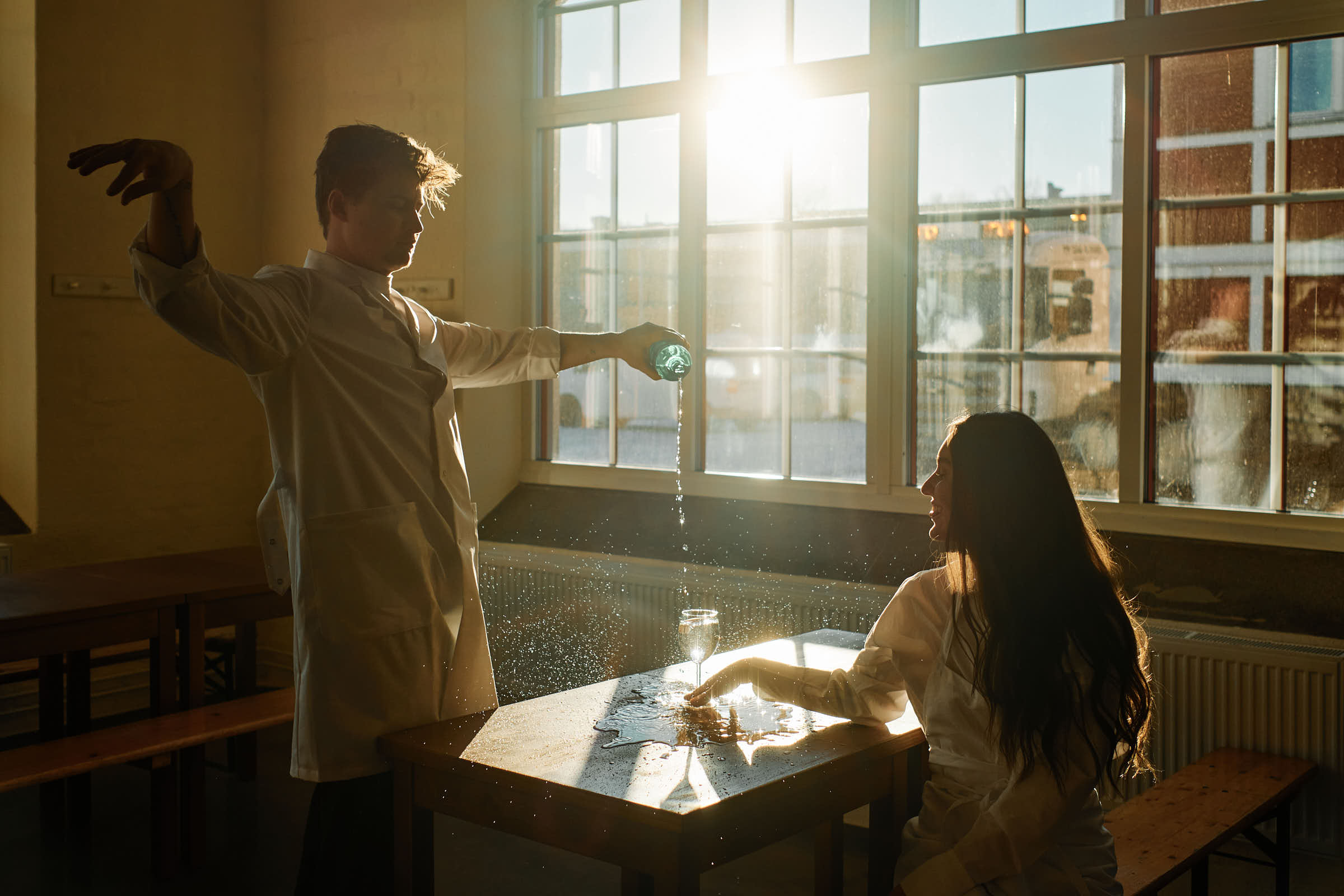 Water being poured at Salt Studio Gävle with golden hour light streaming through industrial windows