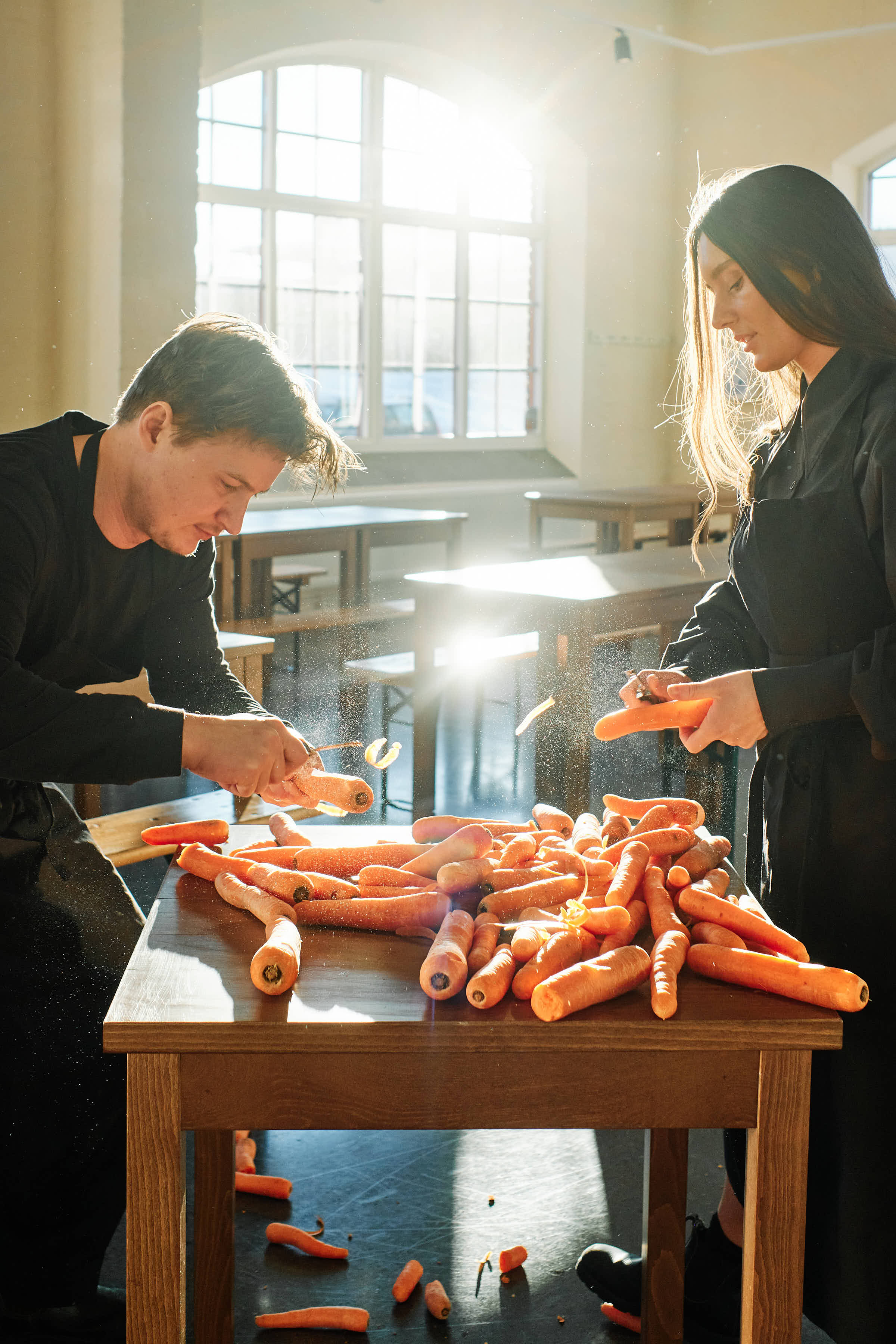 Preparing seasonal carrots in golden backlight at Salt Studio restaurant Gävle