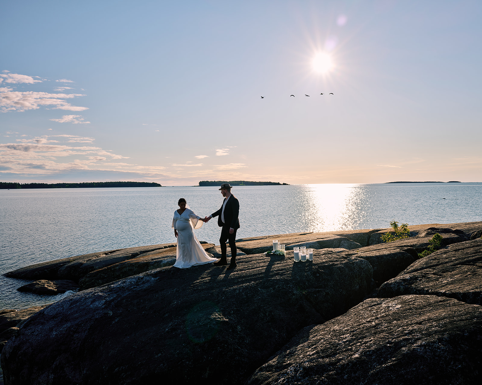Couple on Baltic Sea shoreline at golden hour near Hop Farm Beach Sweden