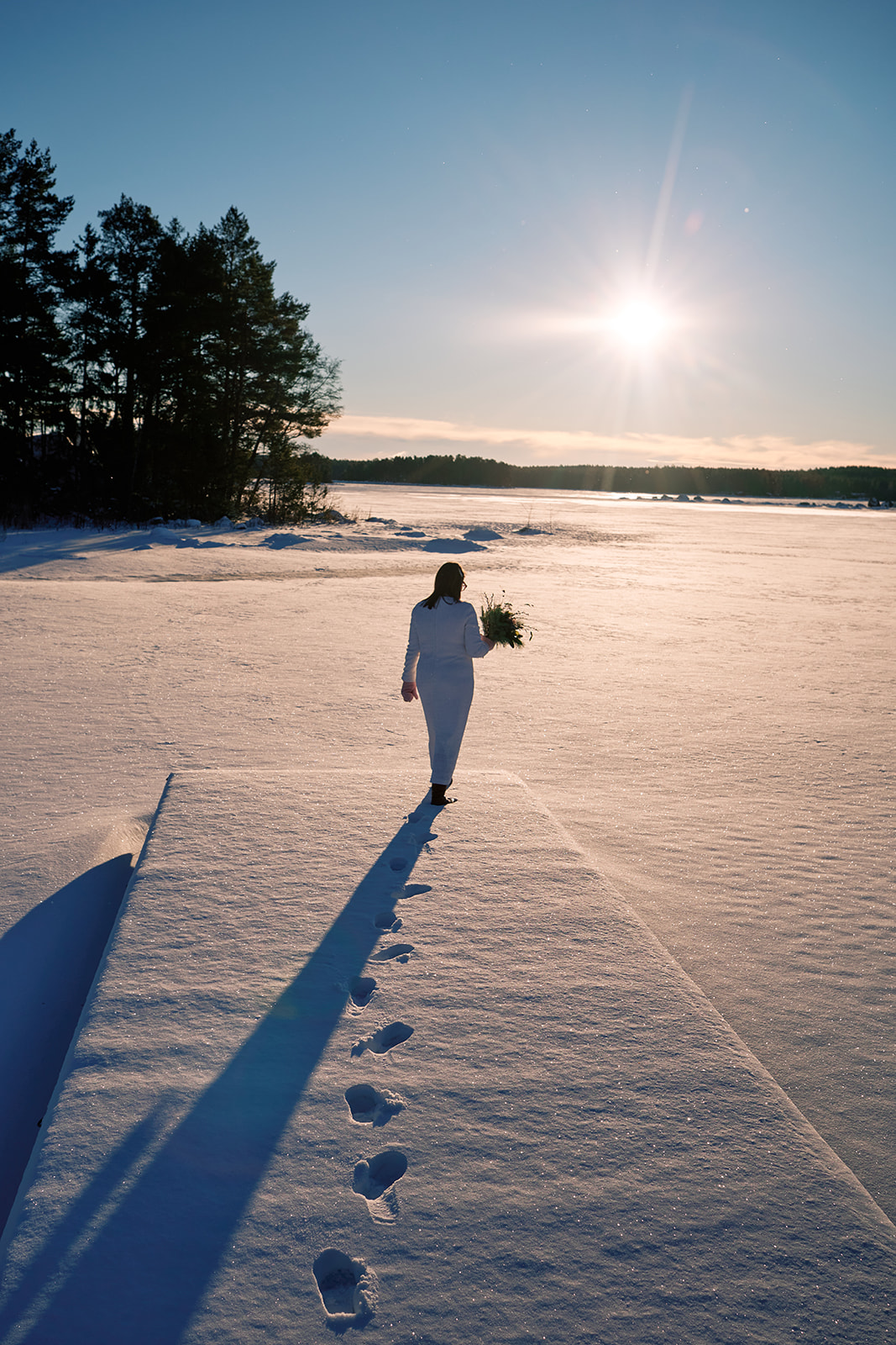 Couple walking through golden light during elopement on Swedish coast